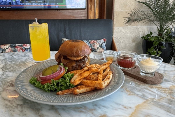 burger with toppings on the side and seasoned fries